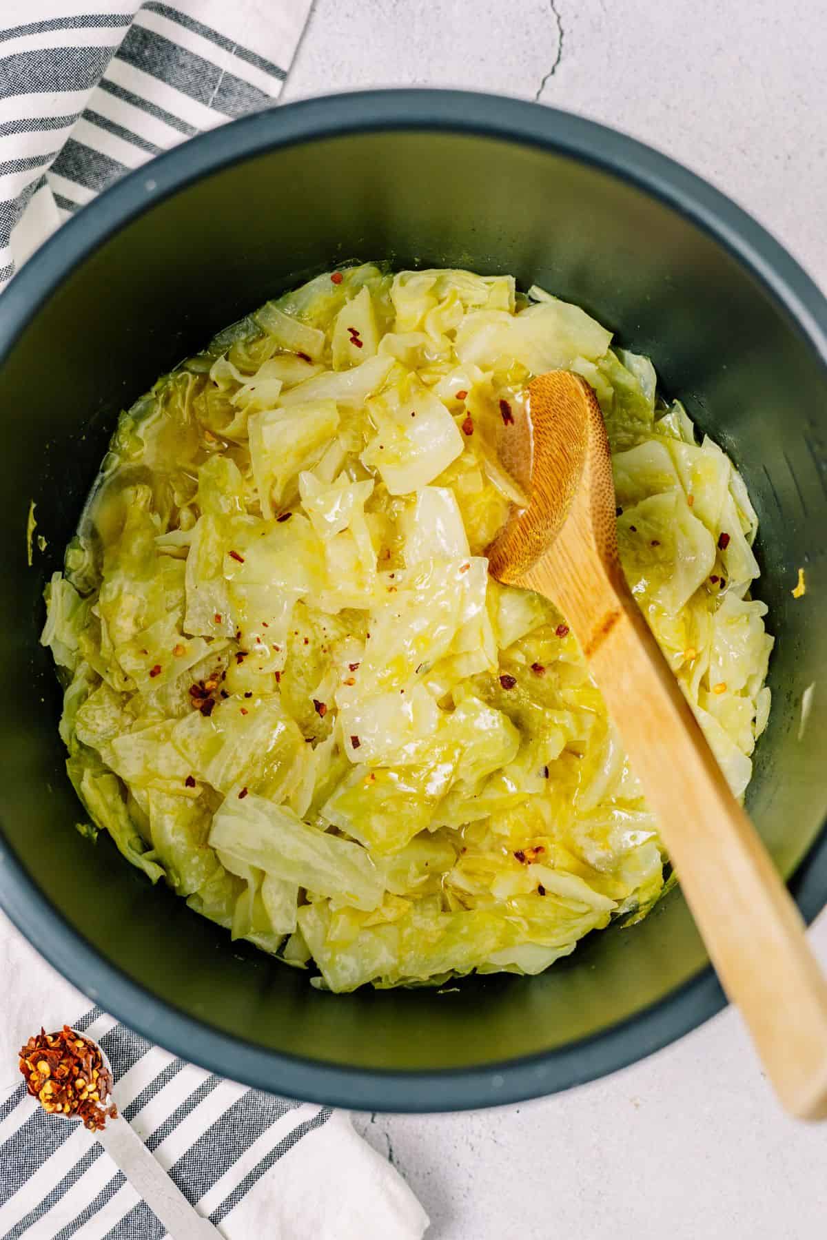 buttery cabbage in the bottom of the Instant Pot Pressure Cooker