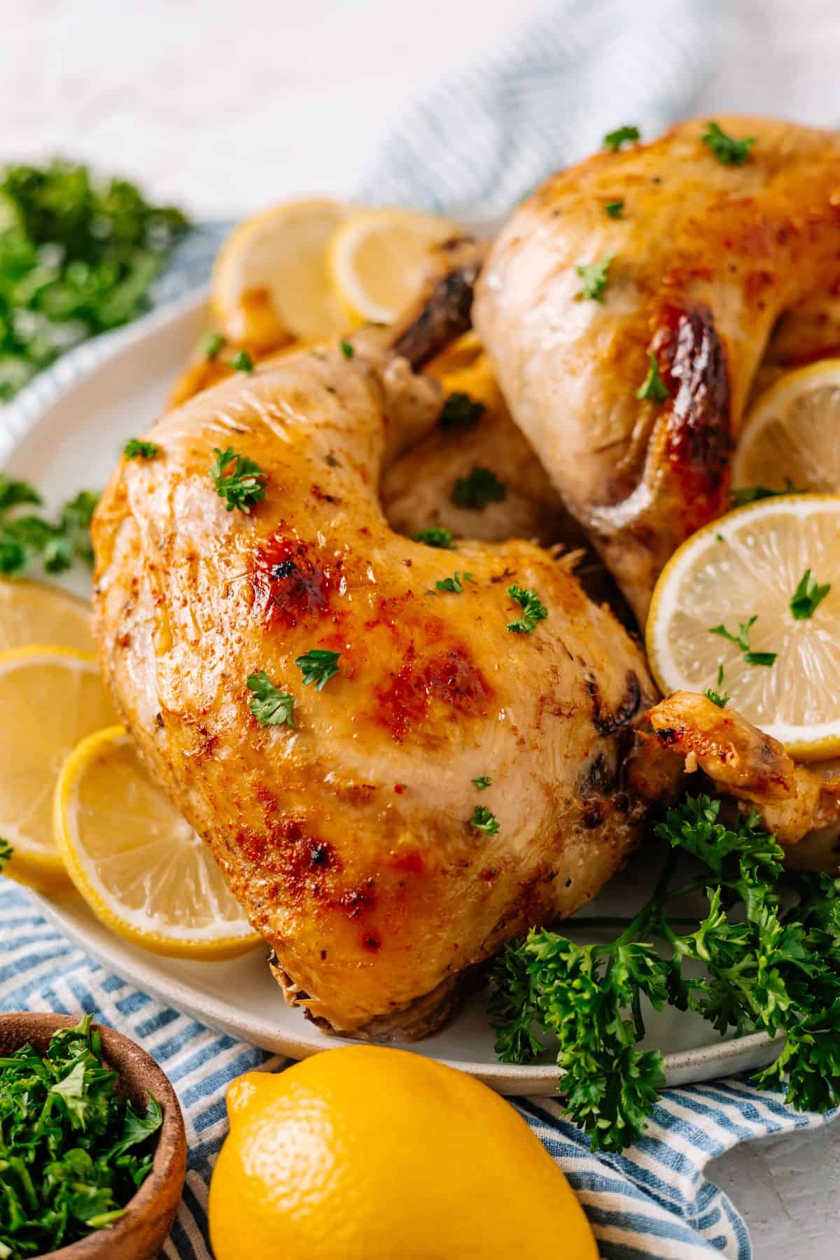 juicy Crockpot Chicken Leg Quarters with slices of lemon and fresh parsley
