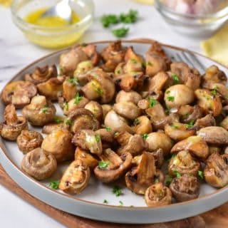 air fryer mushrooms with roasted garlic butter sauce and roasted garlic