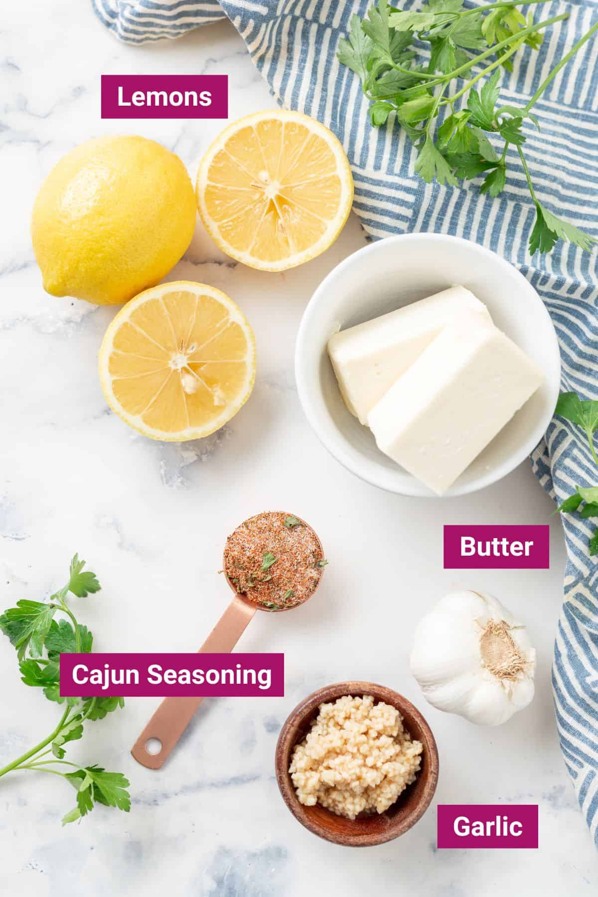 lemons, butter, cajun seasoning and garlic cloves in small bowls