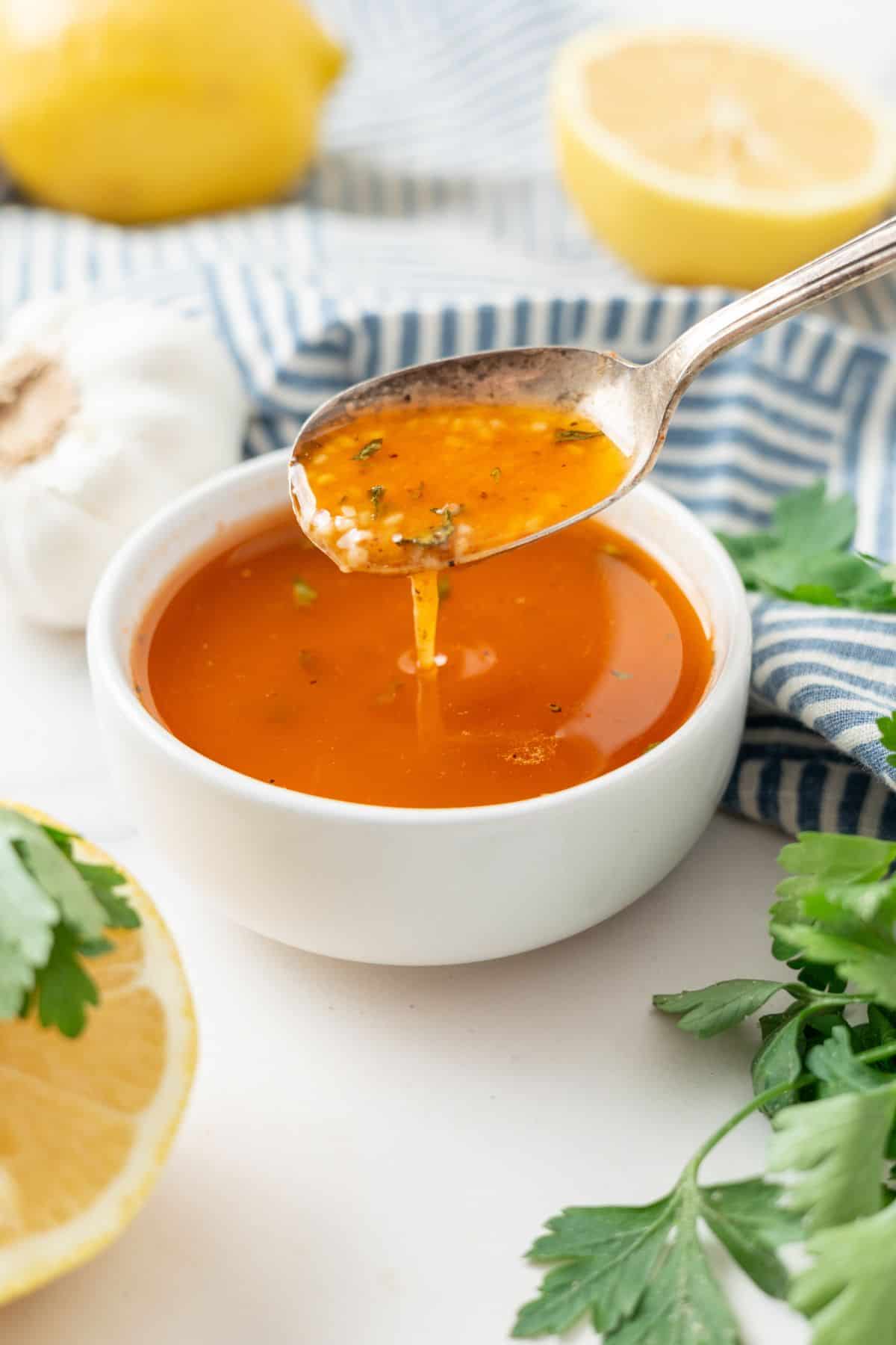 Cajun Garlic Butter Sauce in a small bowl with lemon and parsley