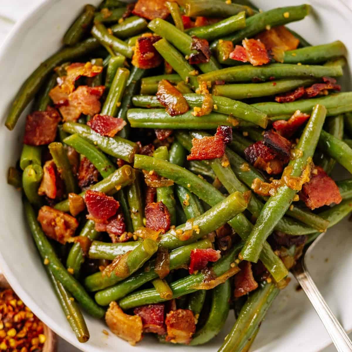 instant pot southern green beans with bacon in a white bowl