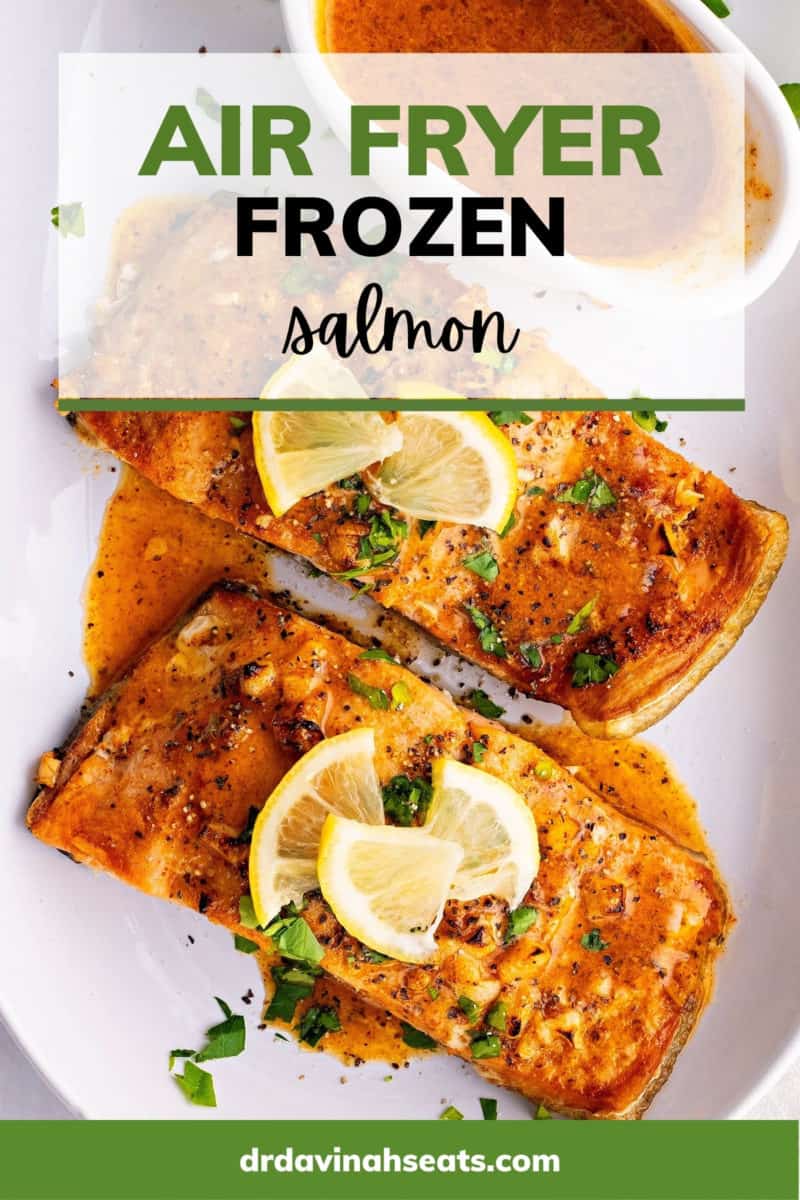 A poster with a picture of two salmon fillets and a bowl of sauce on a plate, with a banner that says, "Air Fryer Frozen Salmon"
