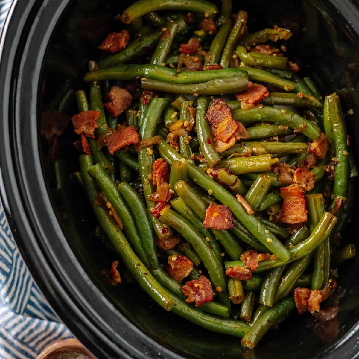 fresh green beans with bacon cooked in a crockpot slow cooker