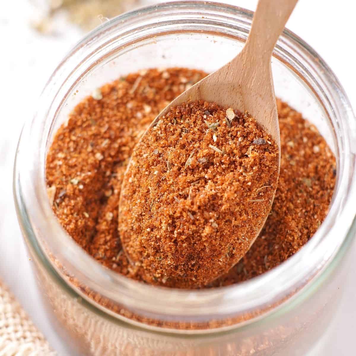 bbq seasoning in a jar with a spoonful scooped out