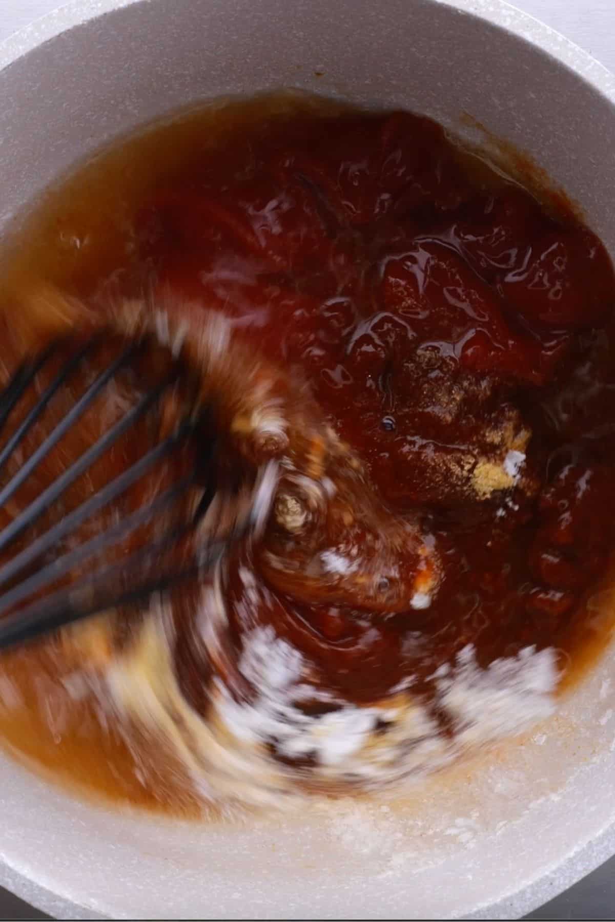 ingredients to make keto in a saucepan being whisked together