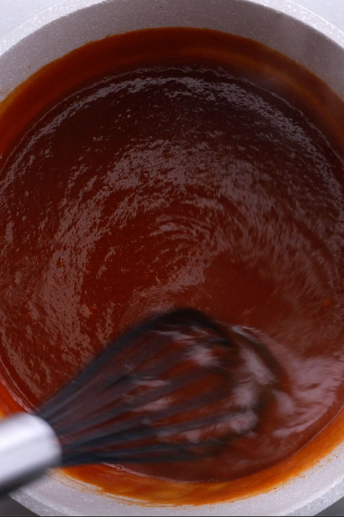 finished keto bbq sauce in a pot with a whisk
