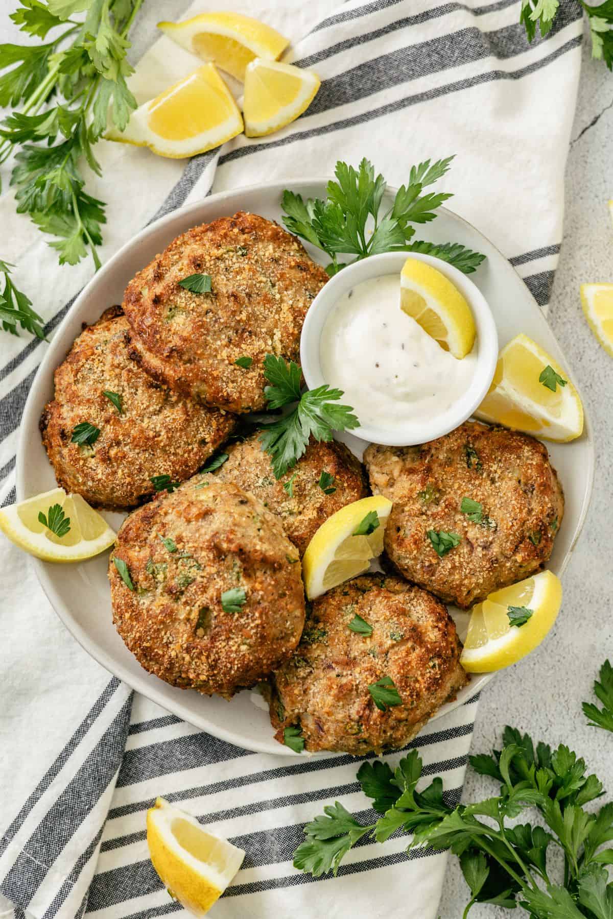 crispy fried salmon patties with mayo dip on a large plate