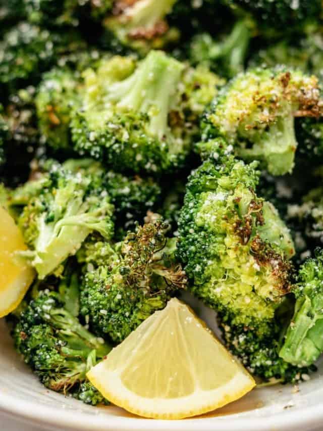 ninja air fryer broccoli on a plate with lemon slices