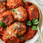 Yummy keto meatballs in a bowl with grated Parmesan on top, ready to satisfy your taste buds.