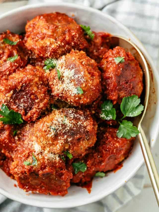 Yummy keto meatballs in a bowl with grated Parmesan on top, ready to satisfy your taste buds.