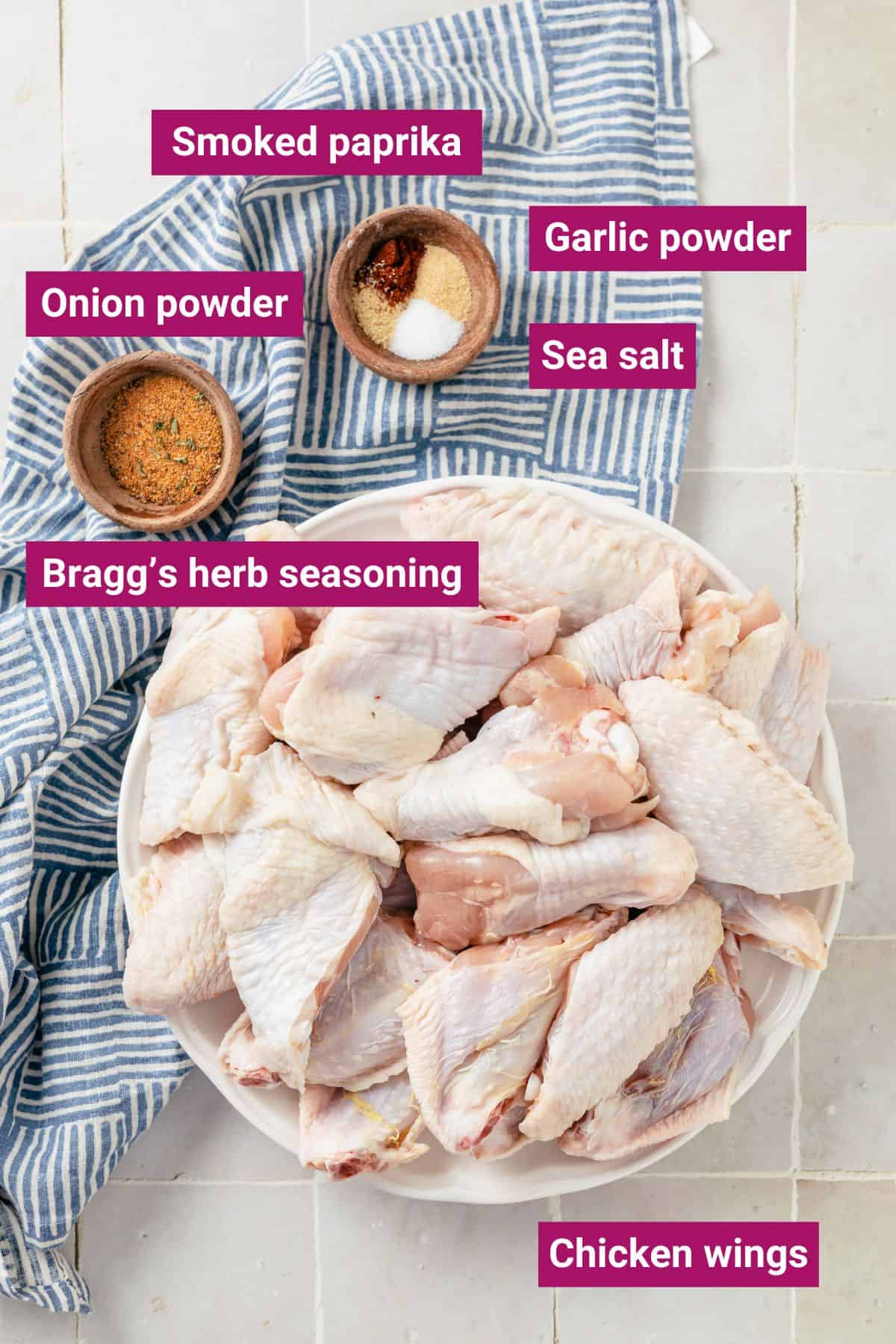 Ingredients for Slow Cooker Chicken Wings arranged in separate bowls: Raw chicken wings (cut into drums and flats or drums-only), Bragg’s herb seasoning, opt