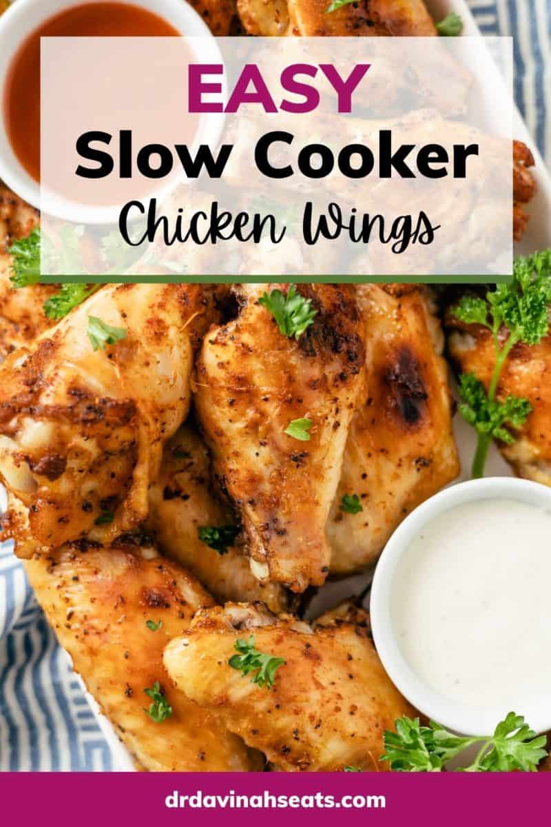 pinterest image of Delicious Slow Cooker Chicken Wings topped with parsley, complemented by a variety of savory dips