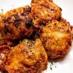 golden-brown air fryer chicken thighs bone-in topped with parsley