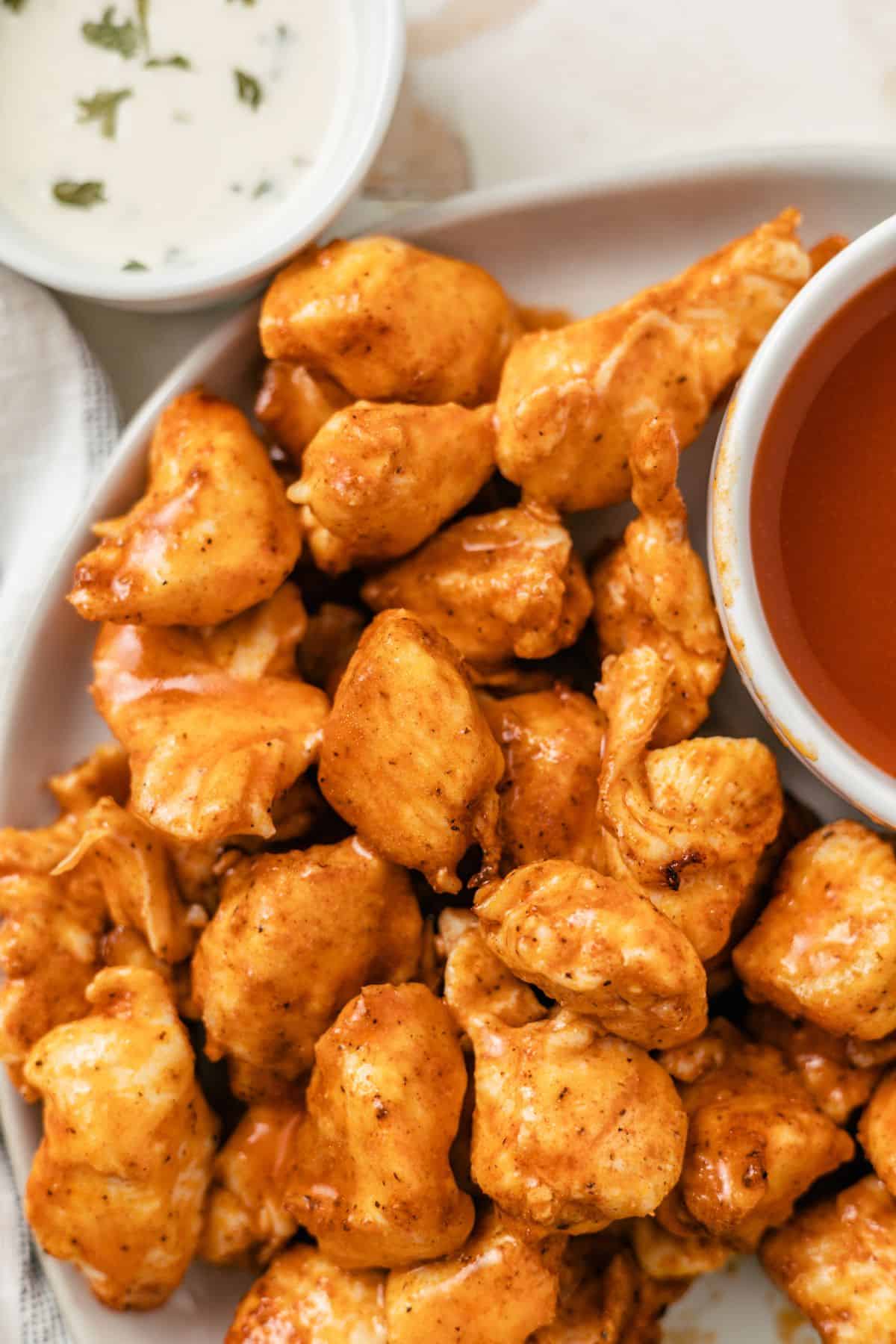 tender air fryer buffalo chicken bites with dipping blue cheese and hot sauce