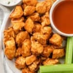 plated air fryer buffalo chicken bites with homemade blue cheese dressing, hot sauce and celery sticks