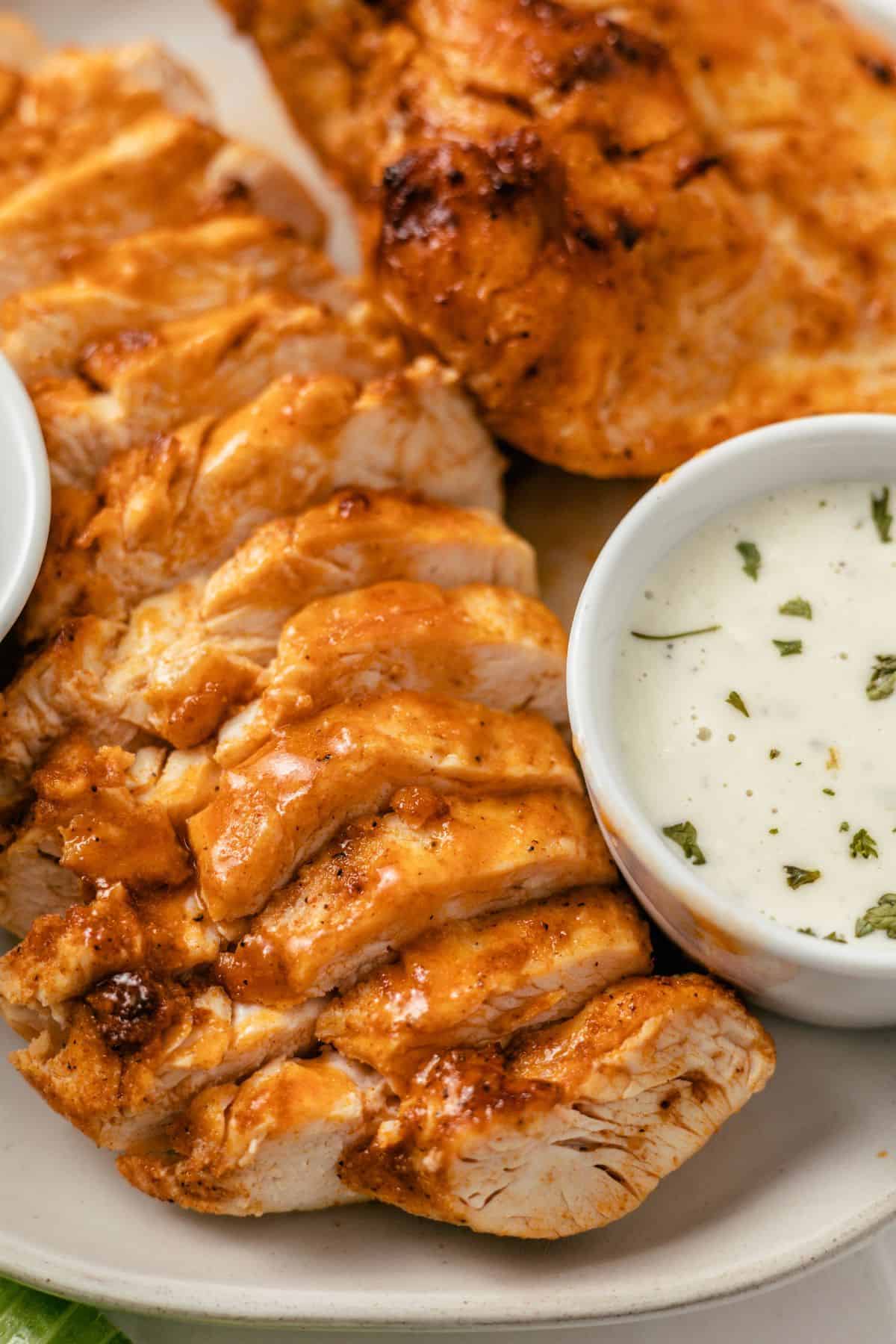 spicy air fryer buffalo chicken breasts sliced with blue cheese dressing