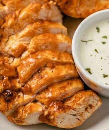 air fryer buffalo chicken breasts plated with blue cheese dressing