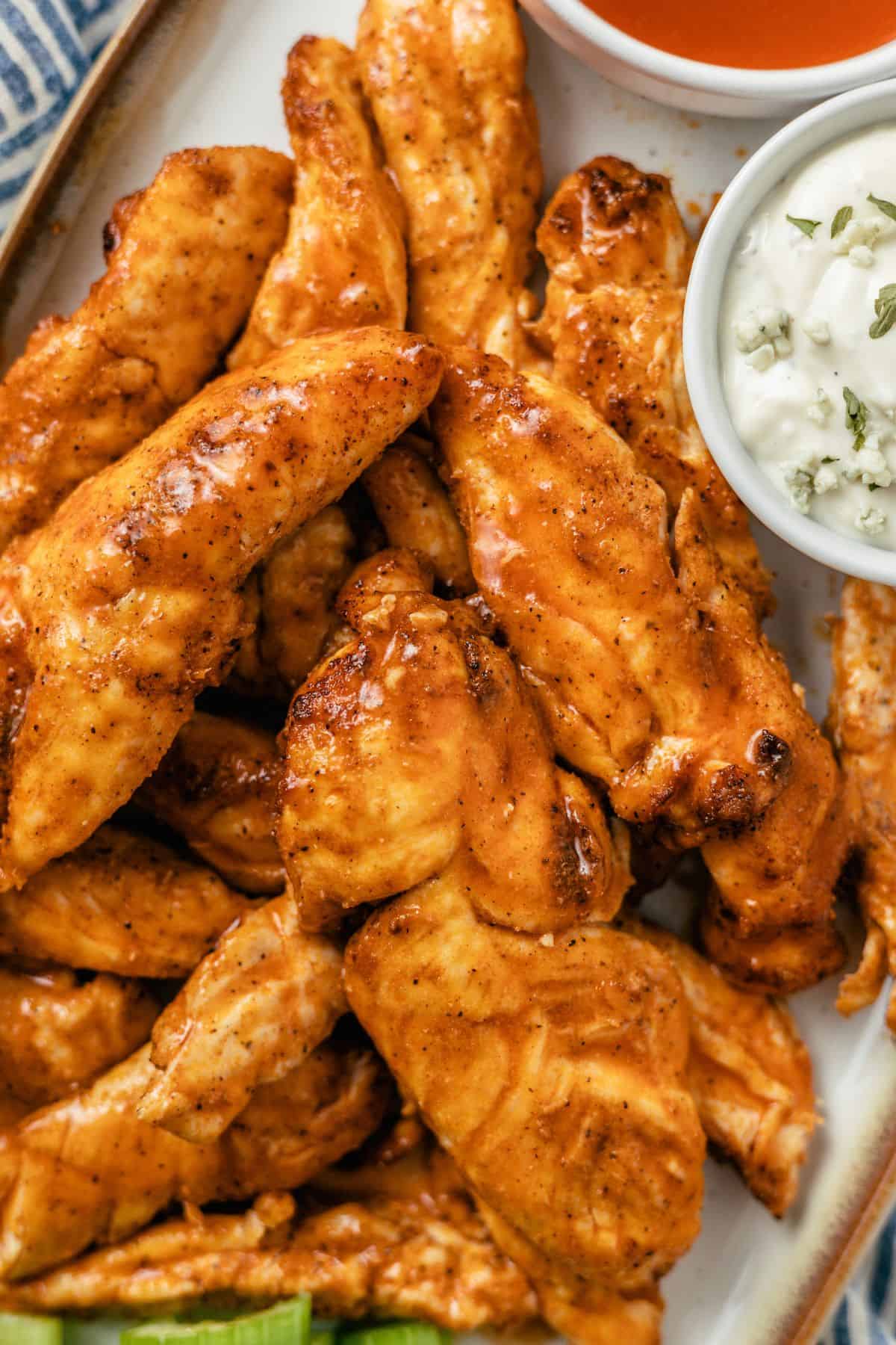 air fryer buffalo chicken tenders with dipping hot sauce and creamy blue cheese dressing