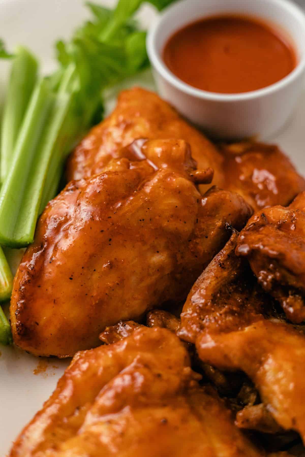 tender air fryer buffalo chicken boneless and skinless thighs served with celery and dipping sauce