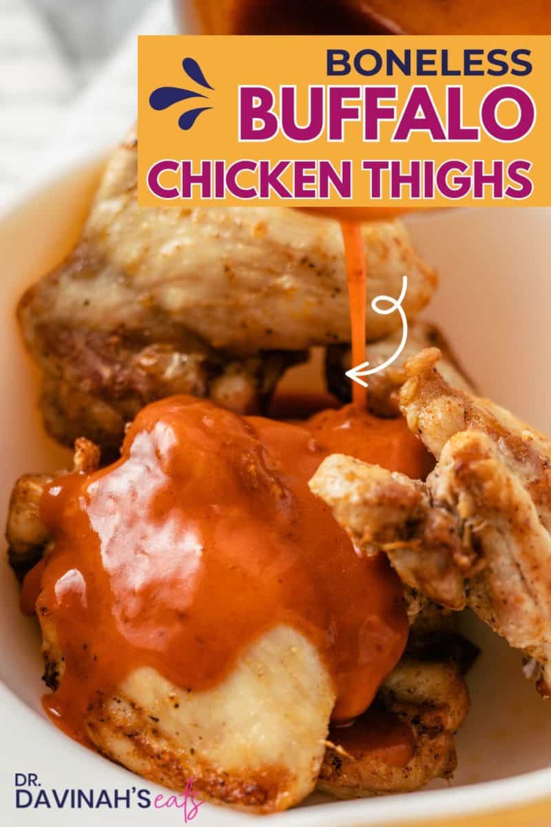 juicy air fryer buffalo chicken thighs with hot sauce in a mixing bowl