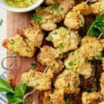 air fryer chicken skewers with creamy garlic parmesan sauce in a sauce bowl