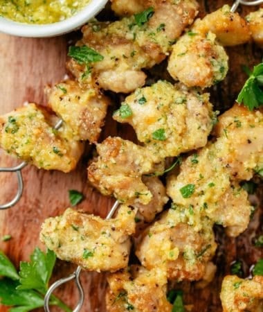 air fryer chicken skewers with creamy garlic parmesan sauce in a sauce bowl