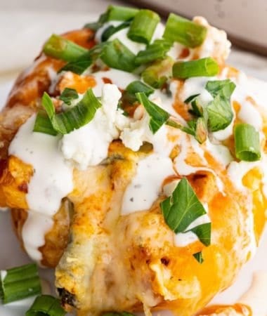 buffalo chicken stuffed pepper topped with ranch dressing, blue cheese, and extra hot sauce