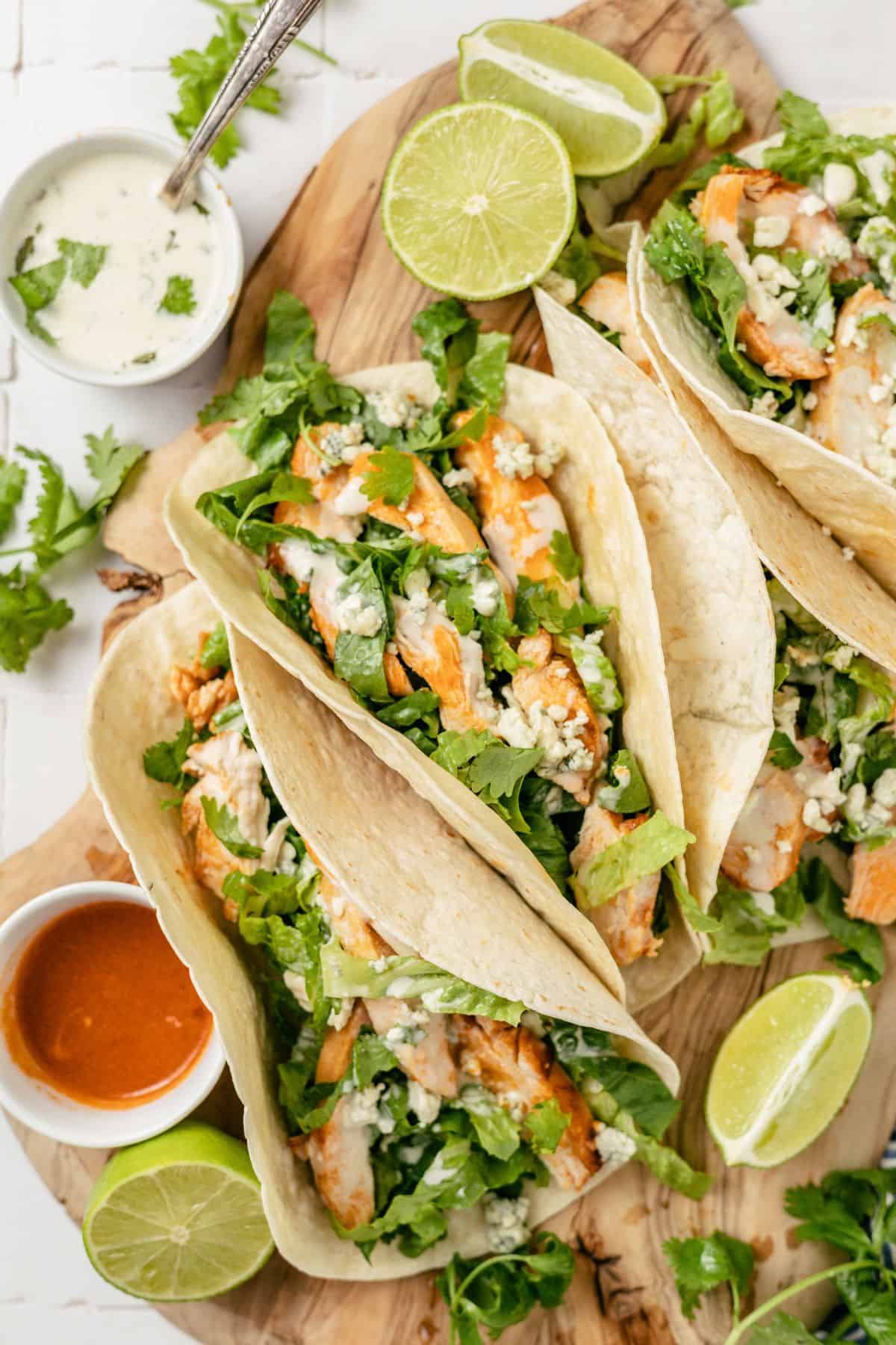 zesty buffalo chicken tacos with hot sauce and blue cheese on the side