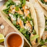 tangy buffalo chicken tacos with a hot sauce dipping cup