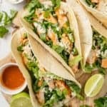 buffalo chicken tacos with a side of spicy hot sauce