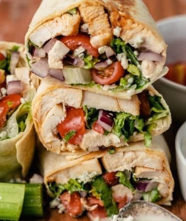 buffalo chicken wraps with fresh celery, dipping sauce, and extra blue cheese