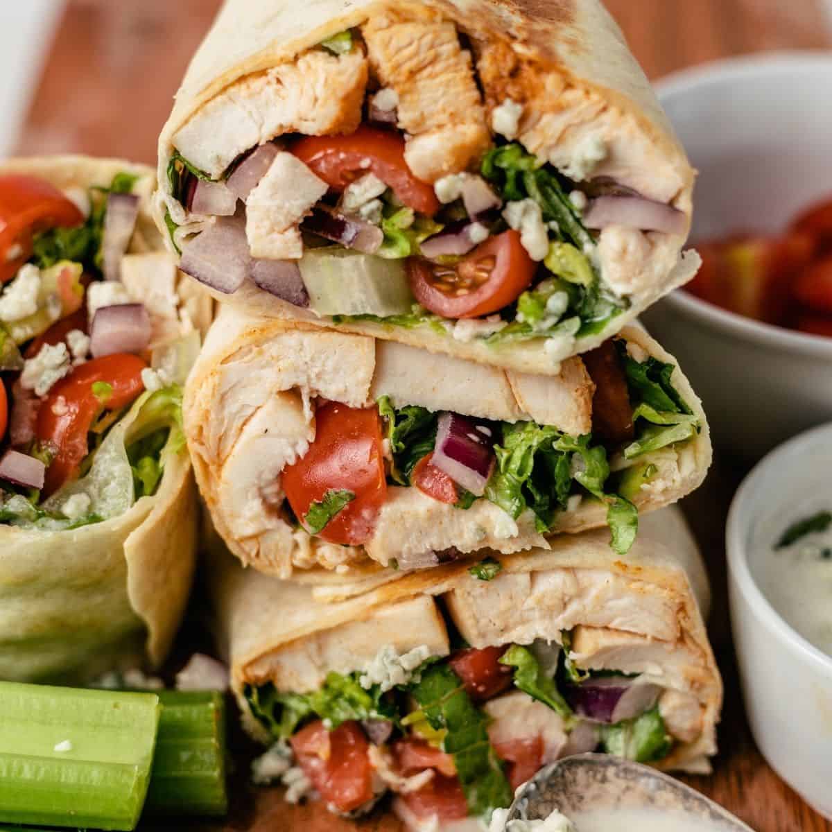 buffalo chicken wraps with fresh celery, dipping sauce, and extra blue cheese