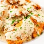 savory garlic parmesan chicken thighs drizzled with creamy garlic parmesan sauce