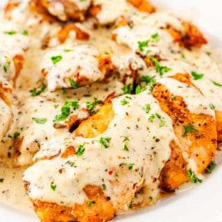 savory garlic parmesan chicken thighs drizzled with creamy garlic parmesan sauce
