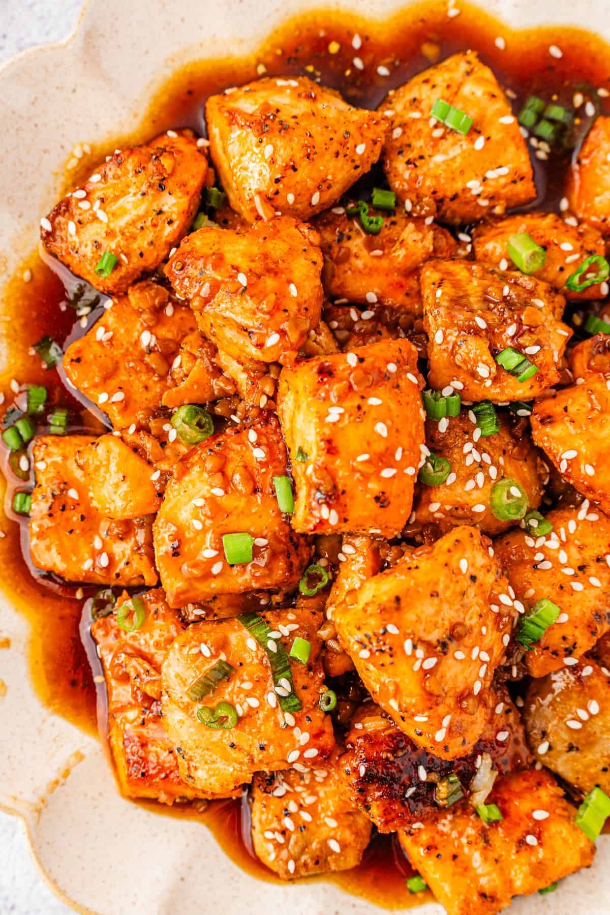 plated honey garlic salmon bites served with honey garlic sauce
