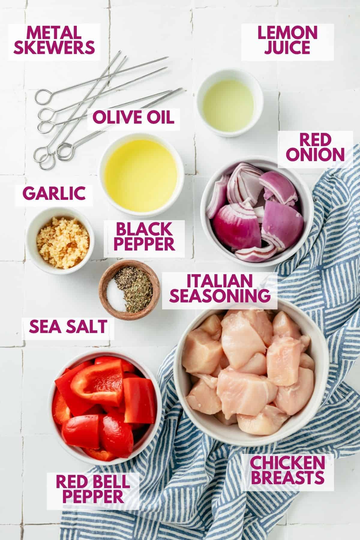 lemon juice, olive oil, red onion, garlic, black pepper, Italian seasoning, sea salt, red bell pepper and chicken breasts in separate bowls