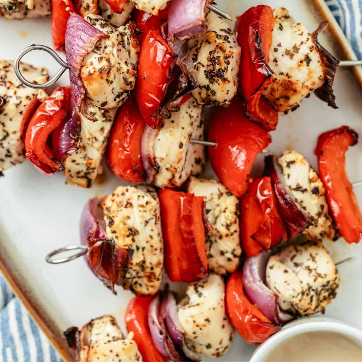 juicy marinated chicken kabobs arranged on a plate