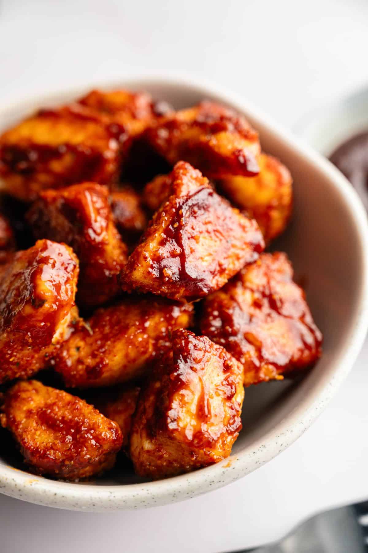 Tender BBQ chicken bites cooked in the air fryer and served in a bowl