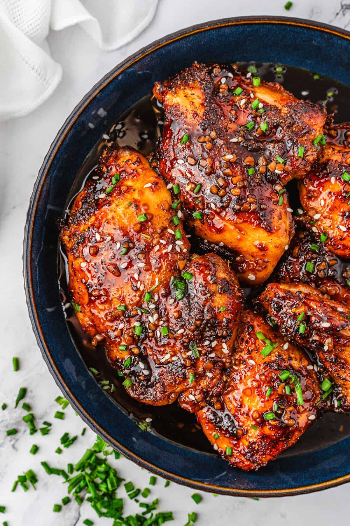 Air fryer chicken thighs brushed with homemade teriyaki sauce before serving