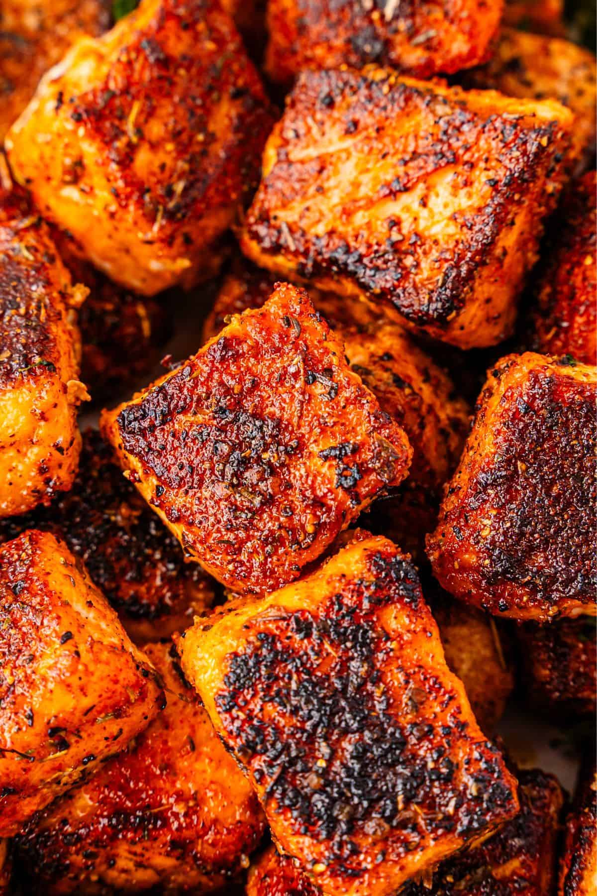 Salmon bites coated in blackened seasoning and pan seared