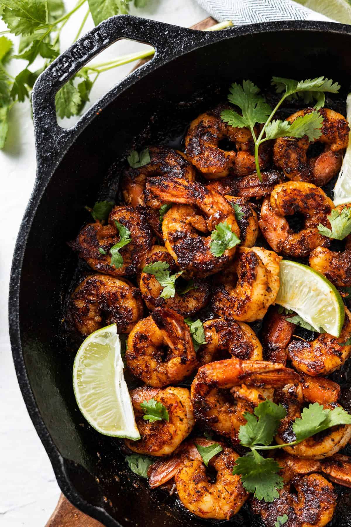 Spicy blackened shrimp garnished with parsley and lemon slices