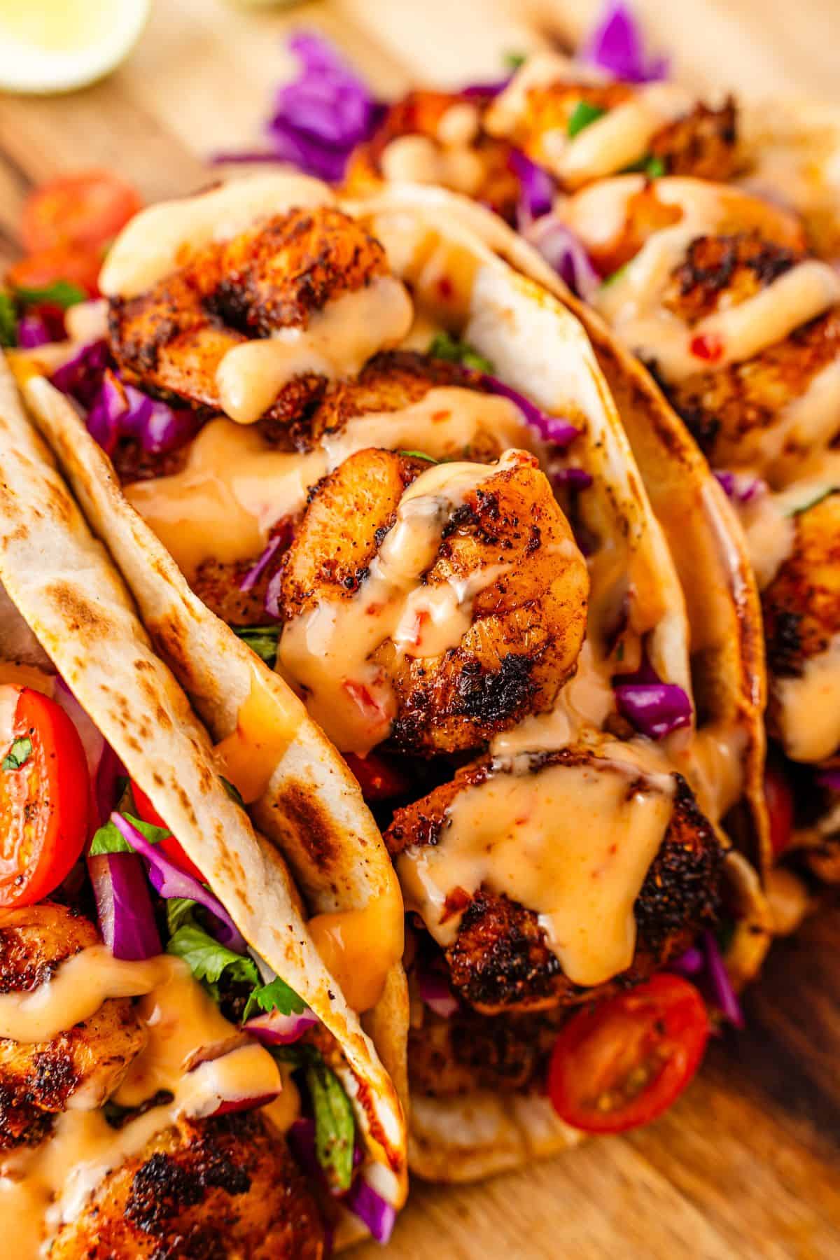 Blackened shrimp tacos served with cabbage slaw and spicy sauce