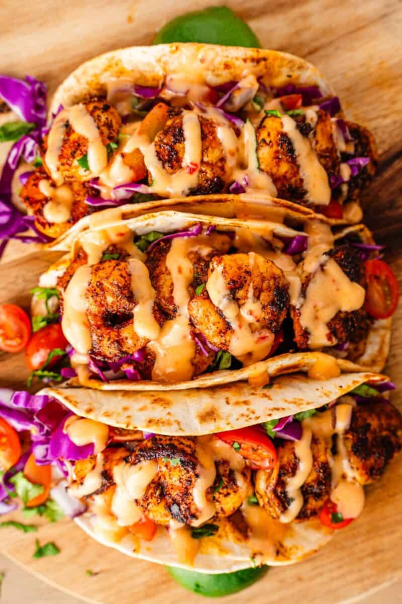 Restaurant style blackened shrimp tacos with bang bang sauce drizzle
