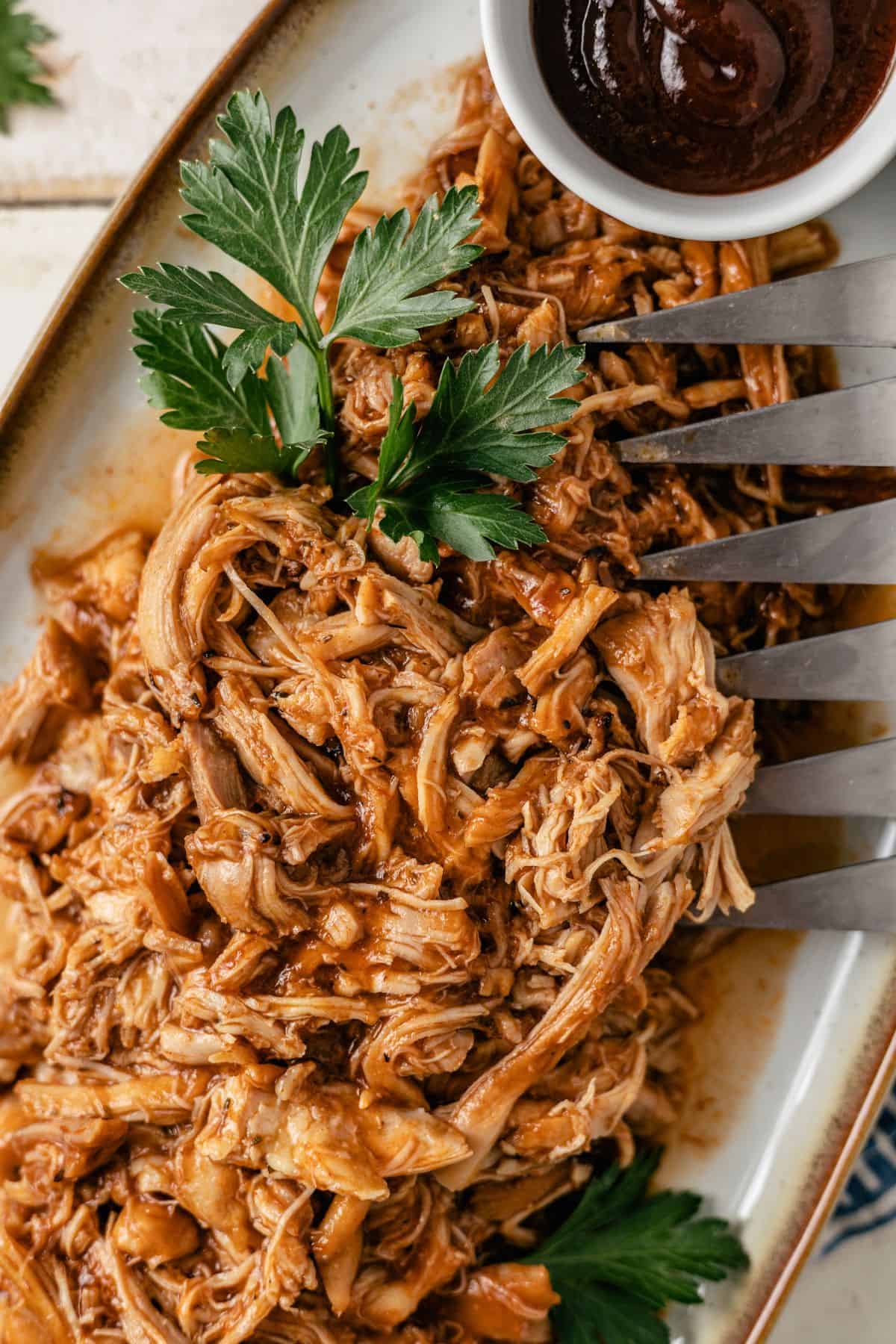 Shredded BBQ chicken made in the Instant Pot, perfect for meal prep or dipping