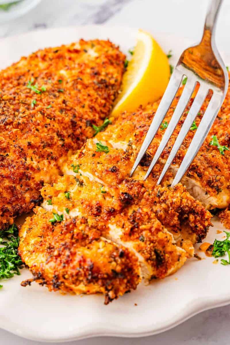 Air fryer Parmesan crusted chicken breast plated on white dish