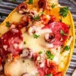 Baked spaghetti squash filled with pizza-inspired sausage sauce and bubbling golden cheese
