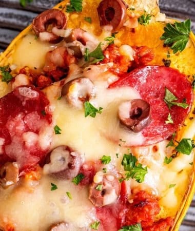 Baked spaghetti squash filled with pizza-inspired sausage sauce and bubbling golden cheese