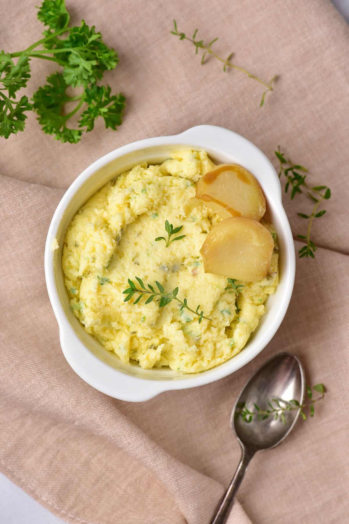 Smooth roasted garlic butter in a serving bowl for bread or steak