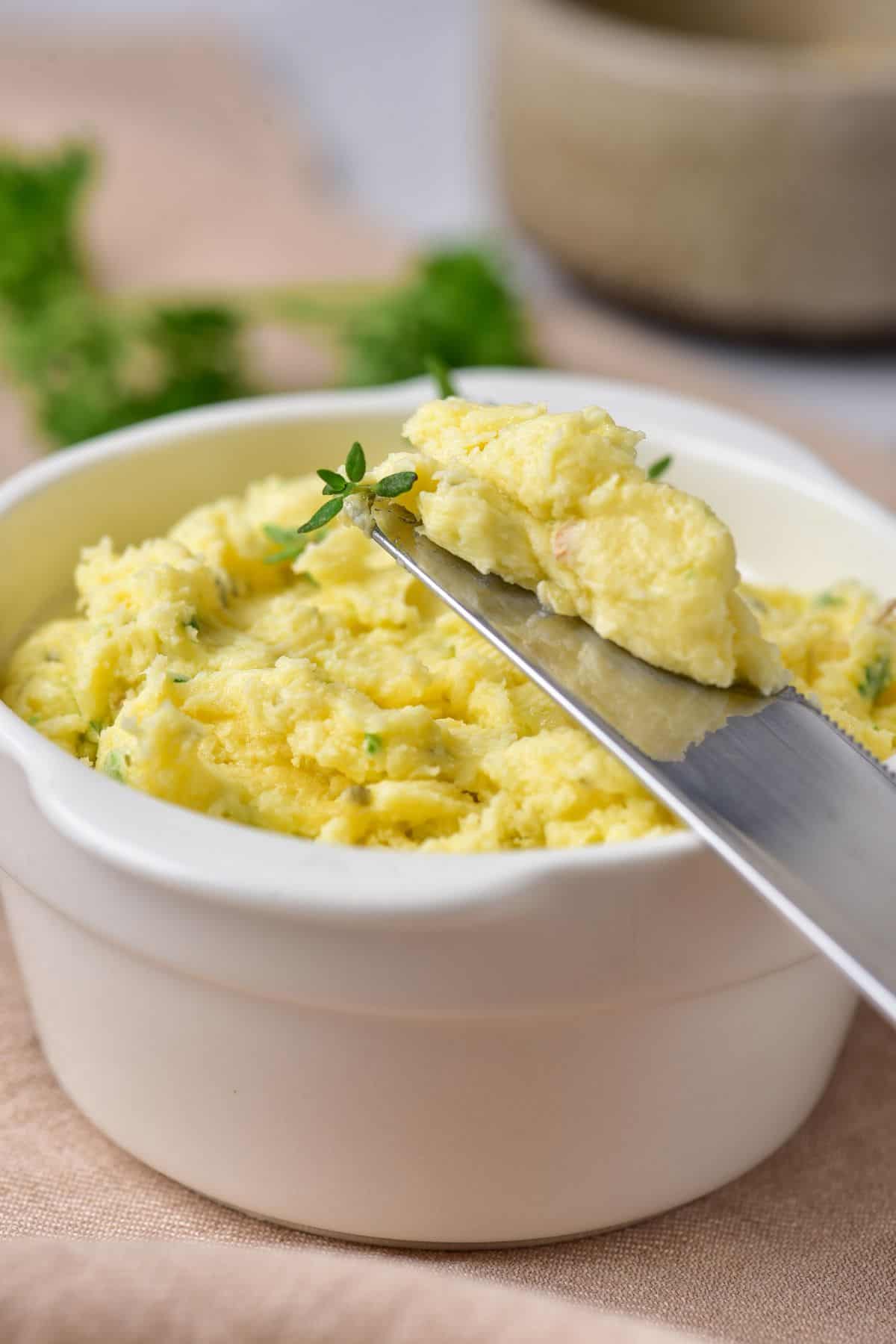 Whipped garlic butter with roasted garlic and herbs in a bowl